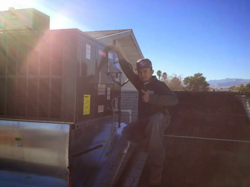 HVAC technician performing AC Tune-Up on a rooftop unit in Ladson